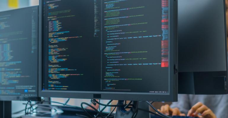 developer monitor screens show software data coding of AI training data
