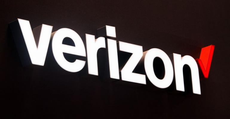 BARCELONA, SPAIN - FEBRUARY 27:  A logo sits illuminated outside the Verizon pavilion during the Mobile World Congress 2017 on the opening day of the event at the Fira Gran Via Complex on February 27, 2017 in Barcelona, Spain. The annual Mobile World Congress hosts some of the world's largest communications companies, with many unveiling their latest phones and wearables gadgets.  (Photo by David Ramos/Getty Images)