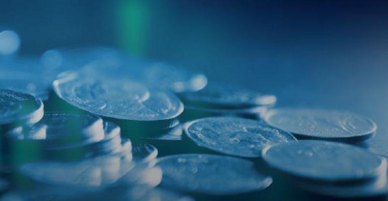 Close-up image of a pile of coins against a blue background