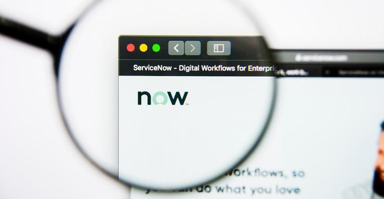 magnifying glass looking at a ServiceNow Now logo on computer screen 