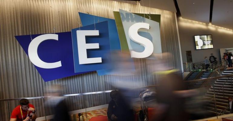 Attendees walk by an International CES logo during the annual event in Las Vegas