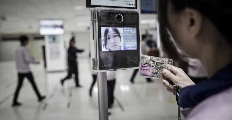 A woman tests facial recognition on her handheld device