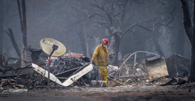 A firefighter searches a burned-out building in Paradise, California, U.S., on Thursday, Nov. 15, 2018.  Photographer: David Paul Morris/Bloomberg