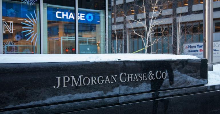 Snow sits on top of signage displayed outside a JPMorgan Chase & Co. bank branch in New York, U.S., on Tuesday, Jan. 9, 2018. JPMorgan Chase & Co. is scheduled to release earnings figures on January 12. Photographer: Daniel Tepper/Bloomberg