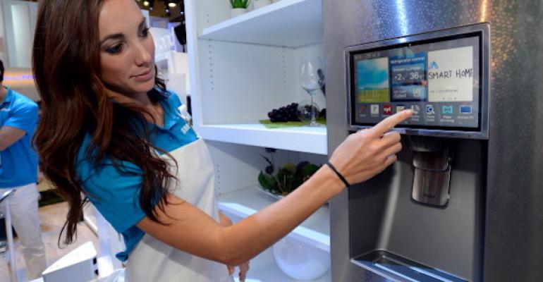 A Samsing employee demonstrates how the screens work on an Internet-connected fridge.