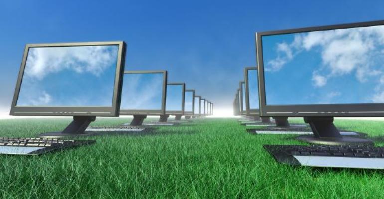 multiple computers in rows sitting on grass Blue sky background