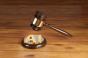 Wooden gavel with brass engraving band and golden AI letter on a round wood sound block