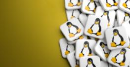 logos of linux penguin in a heap on a table