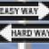 Two road signs stacked reading EASY WAY and HARD WAY