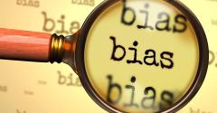 magnifying glass hovering over the word "bias"