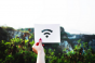 Person holding Wi-Fi symbol on card.png