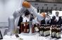 A Kuka AG LBR iiwa robotic arm opens a bottle of beer during a demonstration at the International Robot Exhibition in Tokyo, Japan, on Wednesday, Nov. 29, 2017. The expo runs through Dec. 2. Photographer: Kiyoshi Ota/Bloomberg