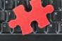 Red puzzle piece on computer keyboard