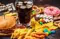 Burger, sweets, chips, chocolate, donuts, soda on a dark background