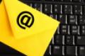 yellow envelope with email symbol on black computer keyboard