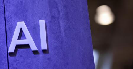 the letters AI on a purple wall
